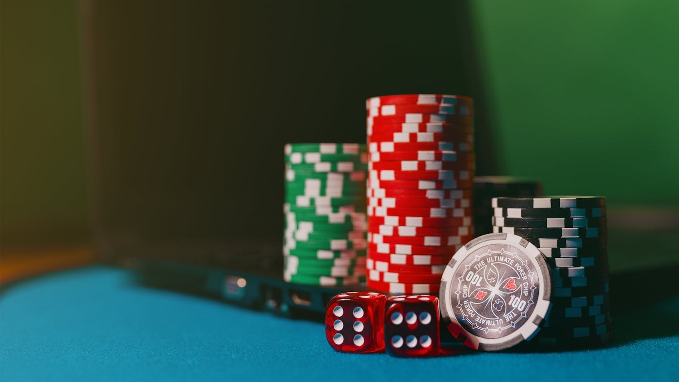 Casino chips en dobbelstenen naast een laptop voor online gokken zonder registratie